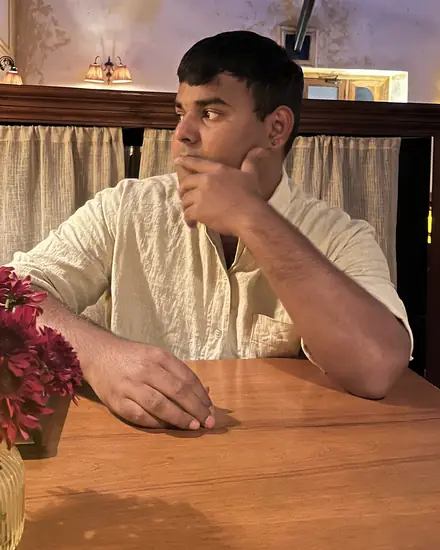 Siddhant at a café table
